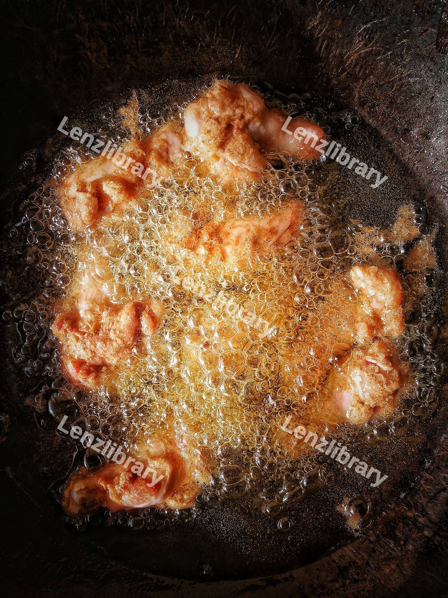 Fried chicken legs in the boiling oil